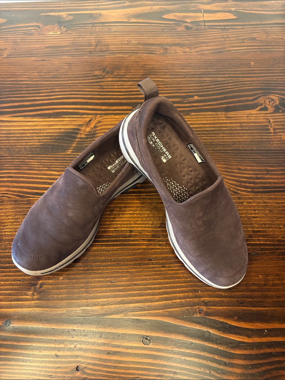 Skechers women’s Slip-On Loafers in Brown with White Trim made for comfort.